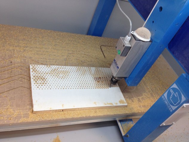 A 3-axis CNC router drills the dots in a sheet of MDF with a 10 mm ballnose tool.